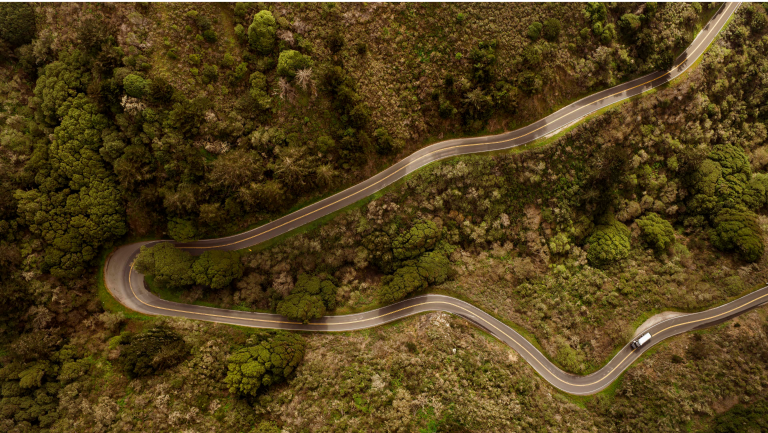 A bird's eye view of a truck on a winding road