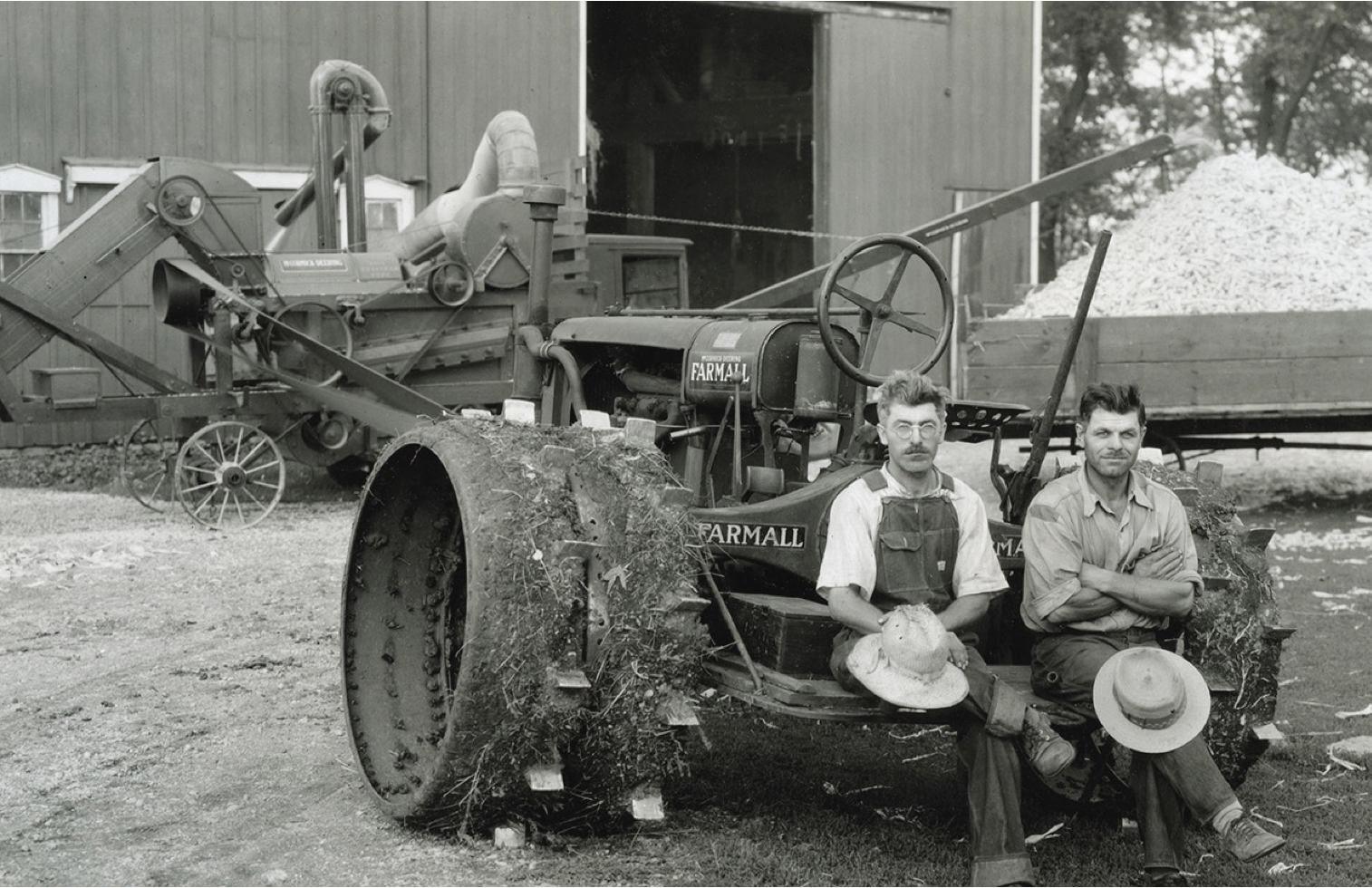 Two people sitting on a tractor