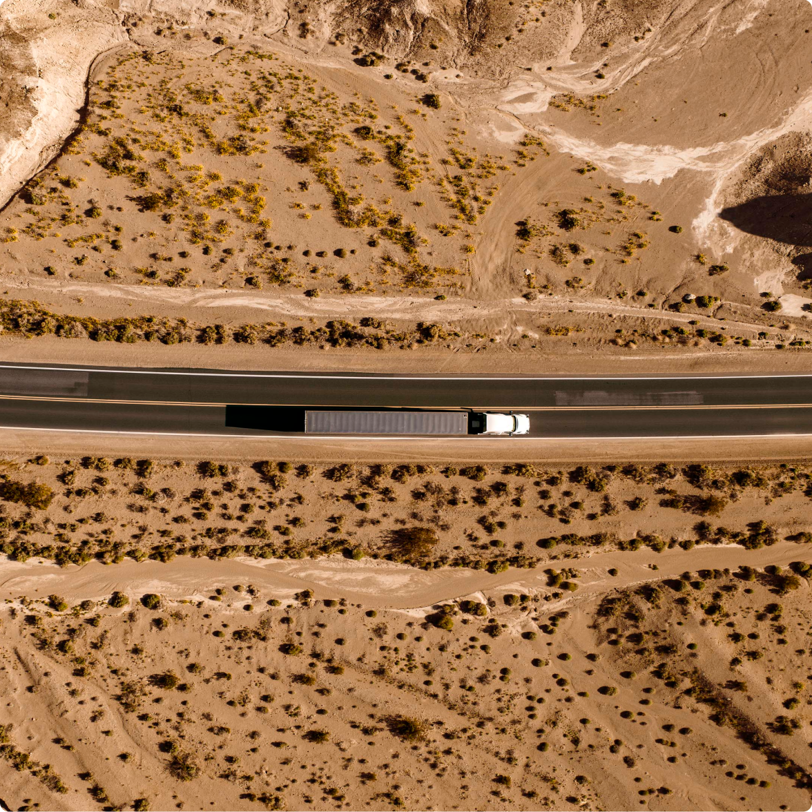 Bird's eye view of a truck driving through a canyon