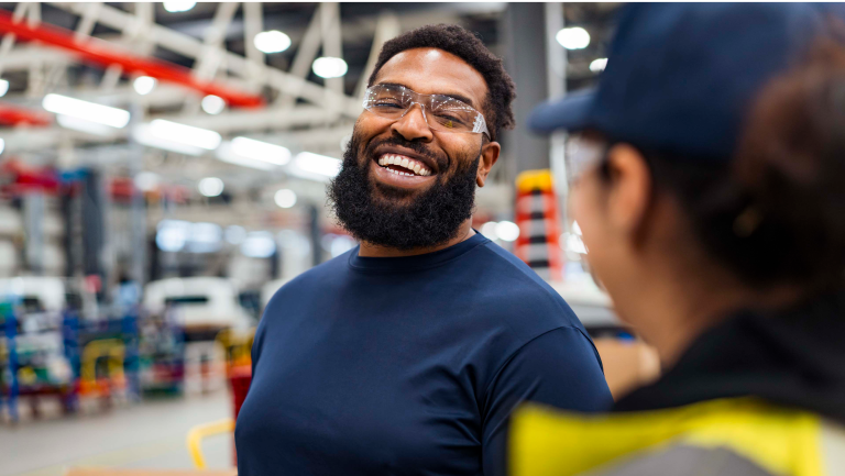 A worker laughing in a plant