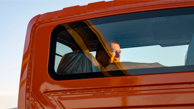 A truck driver looking out the rear window