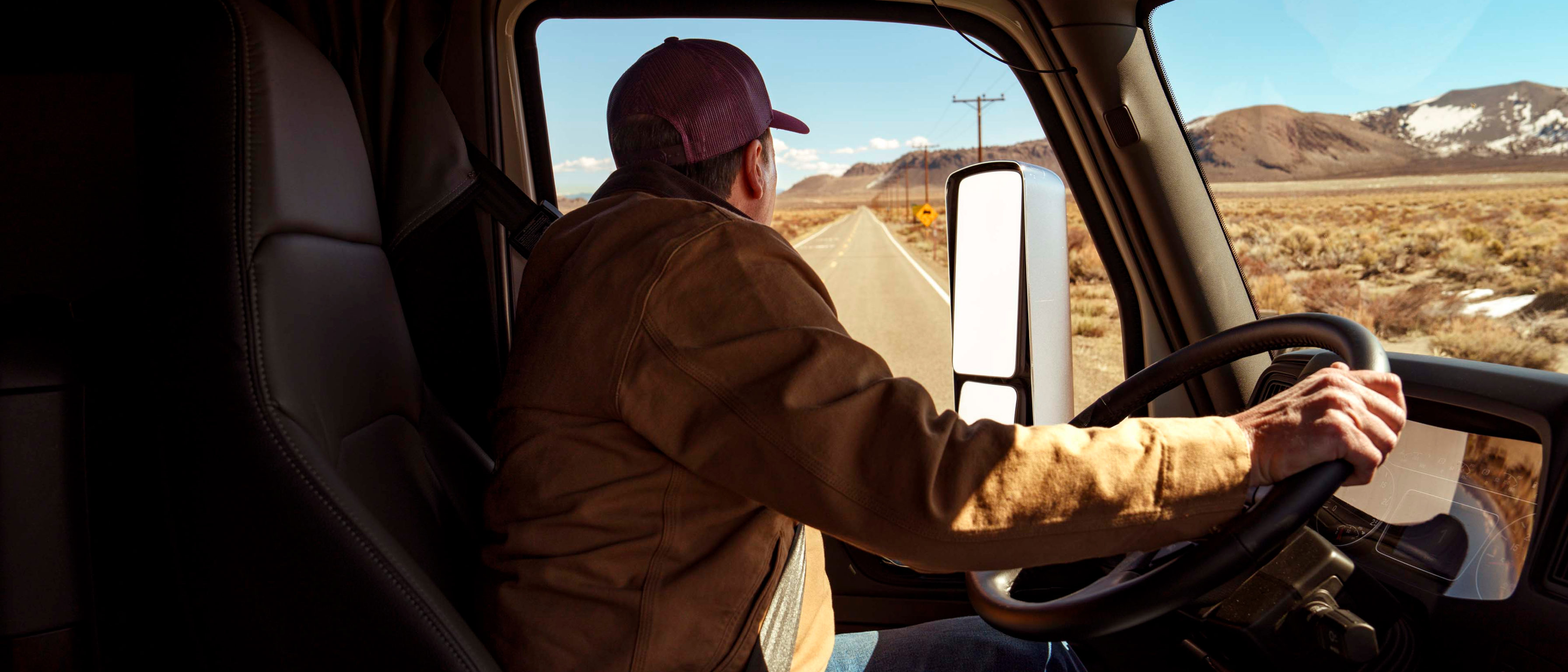 A man in the driver seat of a truck